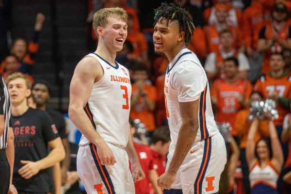 Marcus Domask, fifth year guard and Terrence Shannon Jr., fifth year guard celebrate a timeout called by Rutgers on Jan. 21.
